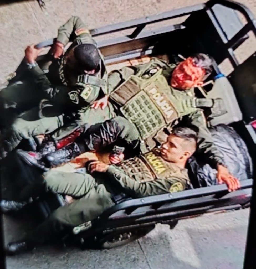 Two brave off duty cops in pyjamas and flip flops helped battle cartel gunmen after a grenade attack in Colombia leaving two suspects dead and three officers injured.