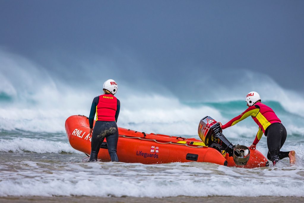Off-duty RNLI lifeguards heroically save drowning man in rough seas at Praa Sands - team battles strong currents for 15 minutes in dramatic pre-season rescue.