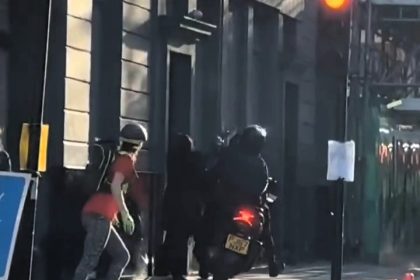 Woman has handbag stolen by moped muggers outside London strip club - scooter mounts pavement as passenger swipes bag and speeds off, sparking outrage from locals.