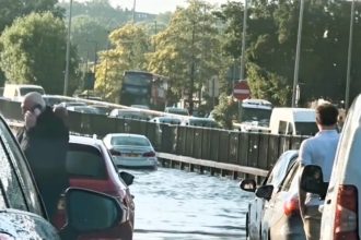 A BMW was stranded on a flooded A41 road near Brent Cross after heavy rain hit on May 12 - causing a three-hour traffic jam as firefighters pumped out the water.