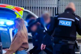 Adult star Bonnie Blue is accused of faking her arrest after fans spotted a prop car linked to film sets in viral footage, sparking backlash over the alleged stunt.