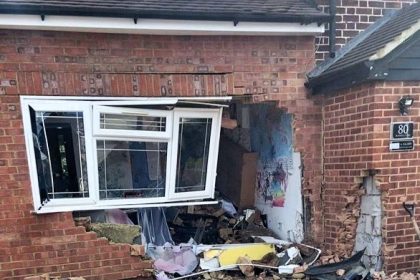 Two men fled after crashing a Mercedes into a West London home, leaving a gaping hole in the living room as shocked witnesses filmed the chaotic and painful escape.