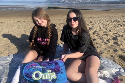 Ghost-hunting parents dubbed the UK’s Addams Family defend using a talking board with their kids during spooky investigations despite backlash and social media bans.