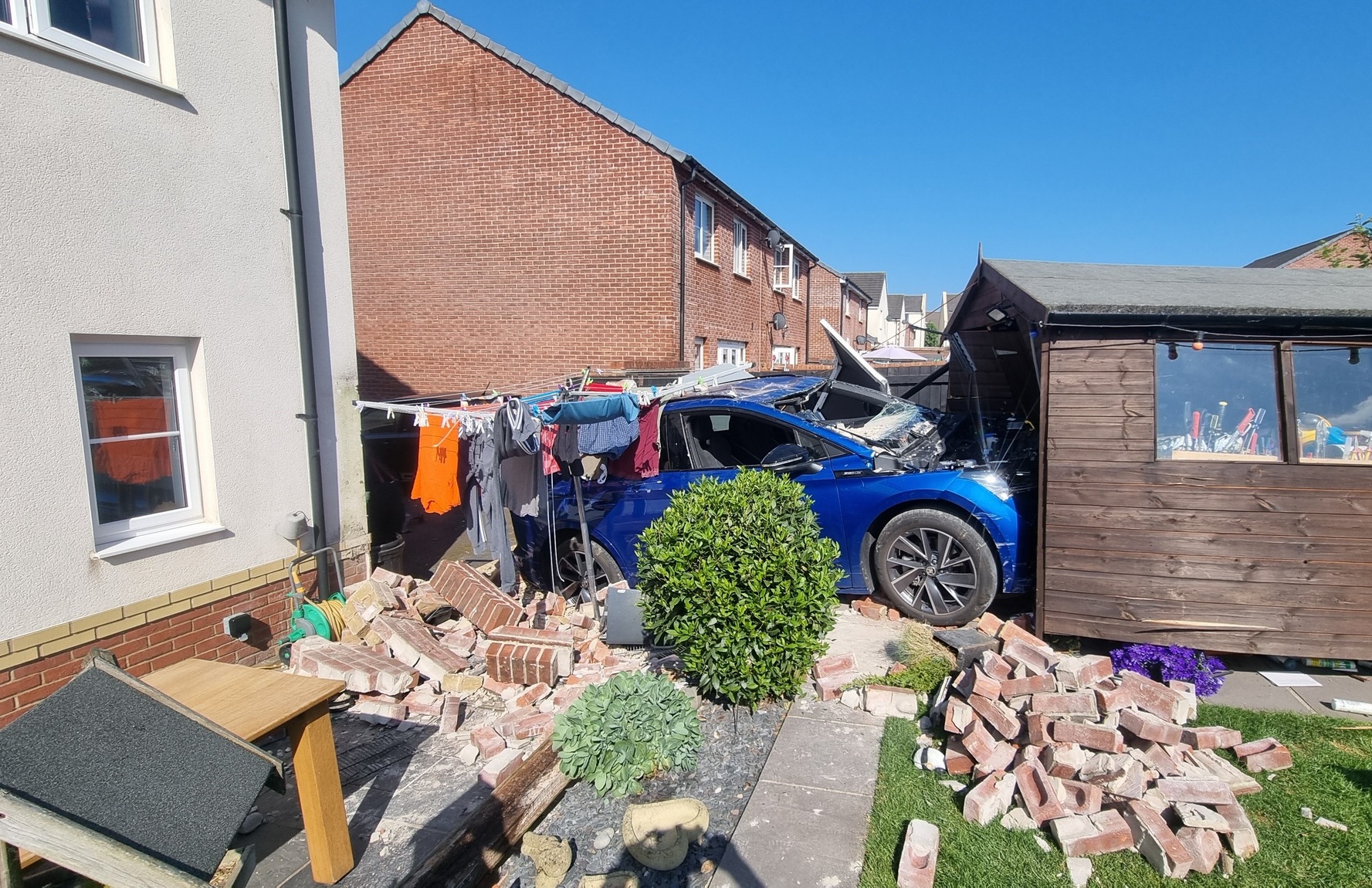 Hapless driver smashes electric car into shed after ploughing through ...
