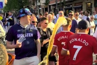 Two Manchester United fans were soaked with beer while walking through a crowd of jeering Spurs supporters in Bilbao ahead of the Europa League final, sparking outrage online.