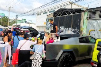 OnlyFans model Vanessa Bohórquez turned heads by selling clothes from the boot of her Cybertruck at a Cancun flea market, drawing crowds with her unique sales setup.