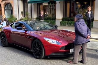 An angry old lady stopped a £180k Aston Martin in Mayfair, scolding the driver for noise as traffic built up and the V12 engine roared off unfazed.