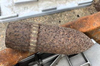 A WWII anti-tank round was found near Dorchester recycling centre on VE Day, prompting an evacuation of two sites as police investigated the explosive discovery.