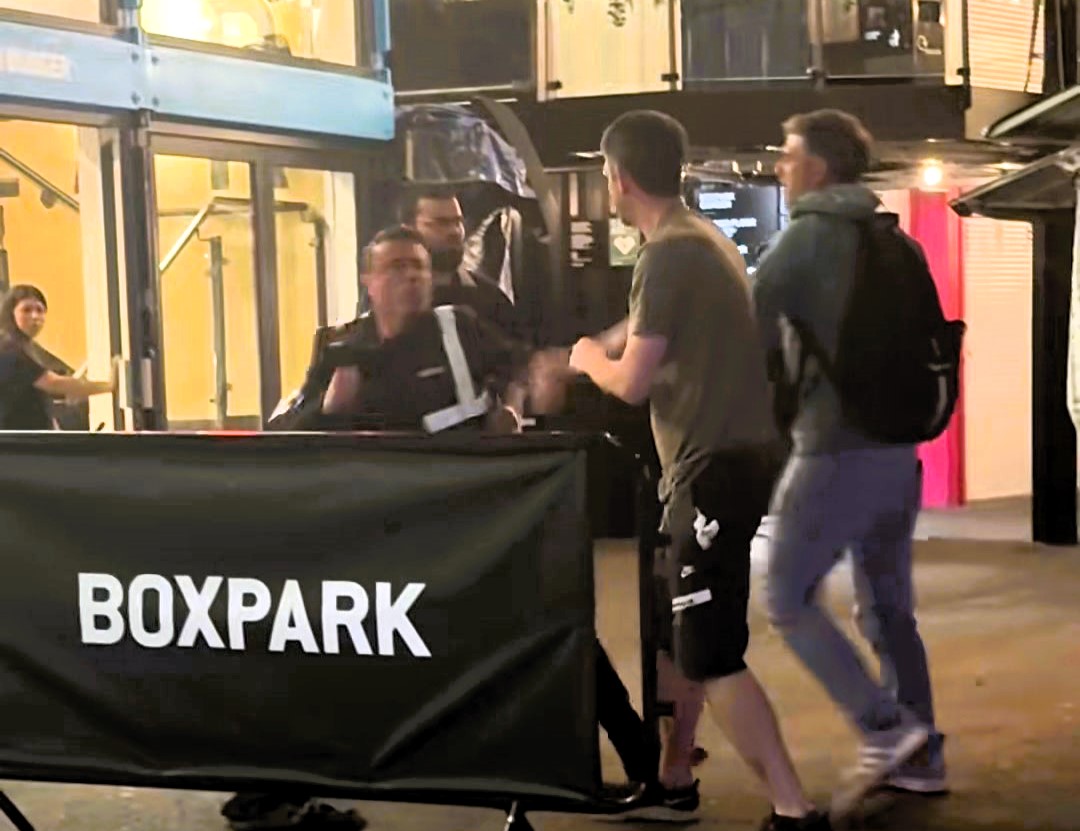 A wild brawl erupted at Boxpark Camden after a punter punched a bouncer to the ground - chaos followed as crowds watched security battle to regain control.
