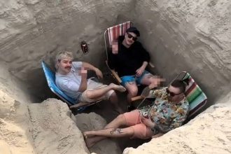 Rock band Nago slammed for filming viral beach video inside a deep sand hole in Poland - critics call it dangerous as the clip racks up 1.7m views on social media.