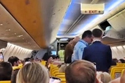 An unruly woman was kicked off a Ryanair flight after vaping and headbutting windows, forcing a diversion to Faro and ending in police restraint and hospital care.