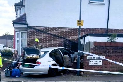 BMW driver crashes into house in 20mph Harrow zone then flees scene on foot - police and fire crews respond, no injuries reported, locals left stunned by wreck.