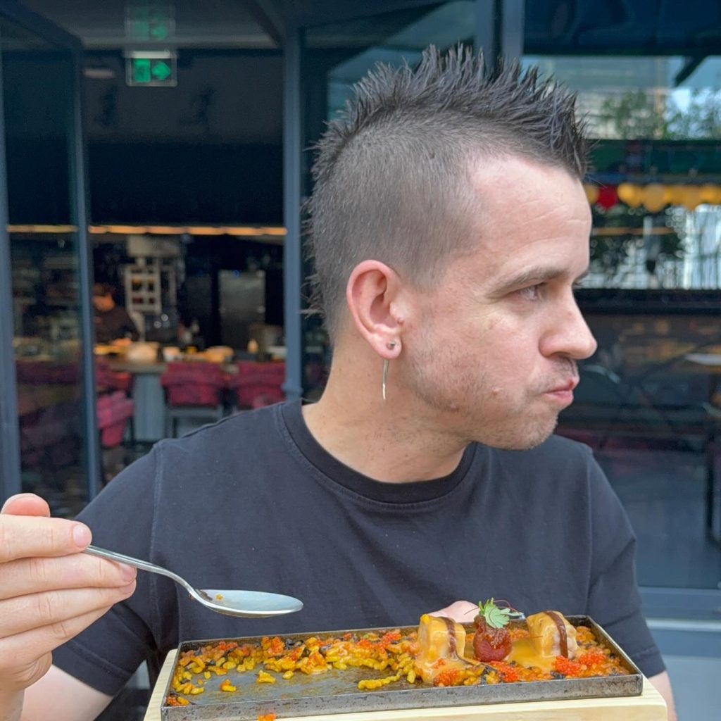 Ed Sheeran dines at Michelin-starred chef Dabiz Muñoz's StreetXO in Madrid, savoring global fusion dishes including famed creations inspired by fish semen delicacies.
