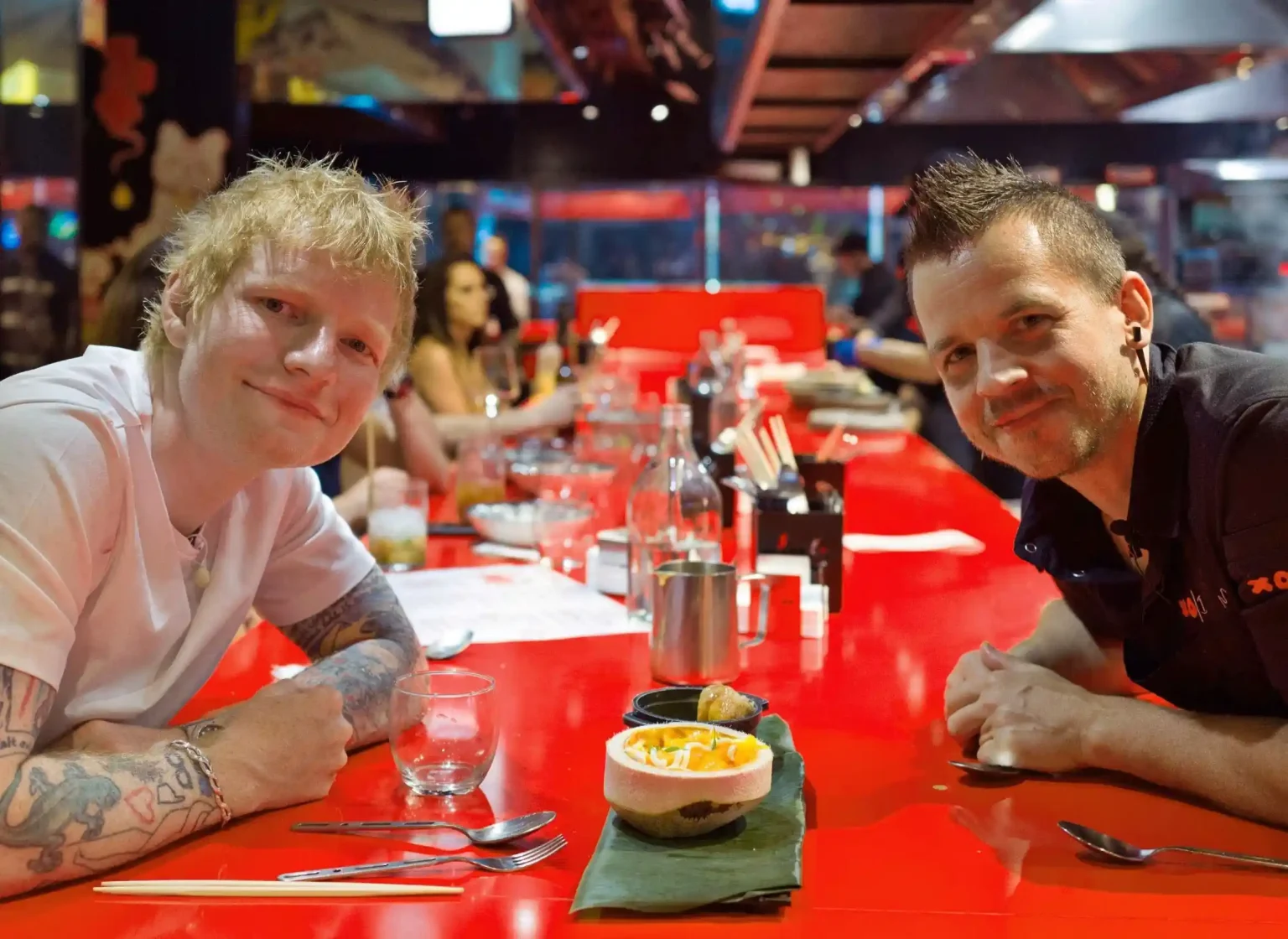 Ed Sheeran dines at Michelin-starred chef Dabiz Muñoz's StreetXO in Madrid, savoring global fusion dishes including famed creations inspired by fish semen delicacies.