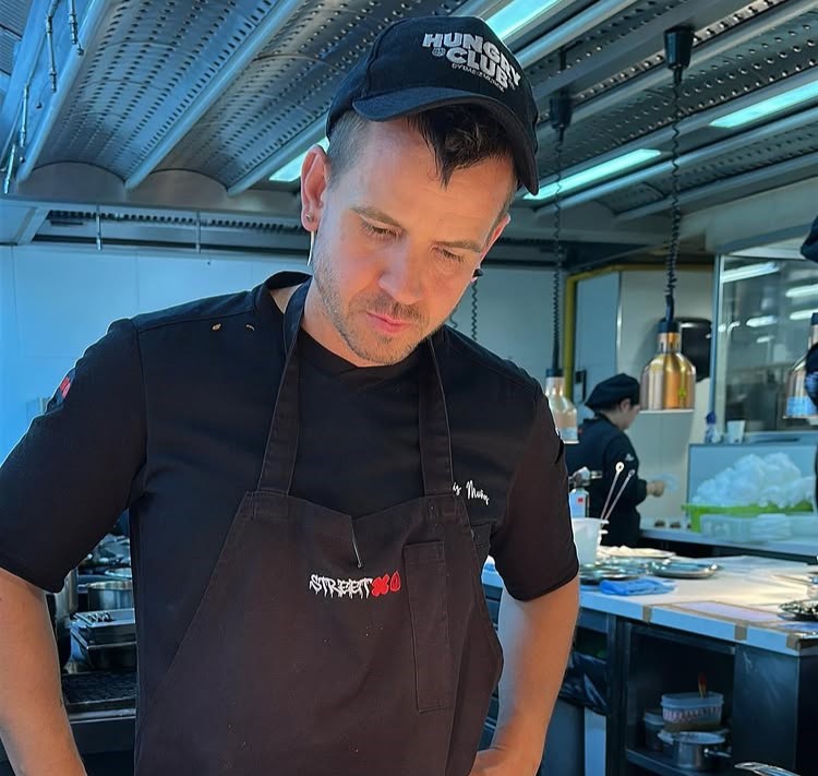Ed Sheeran dines at Michelin-starred chef Dabiz Muñoz's StreetXO in Madrid, savoring global fusion dishes including famed creations inspired by fish semen delicacies.