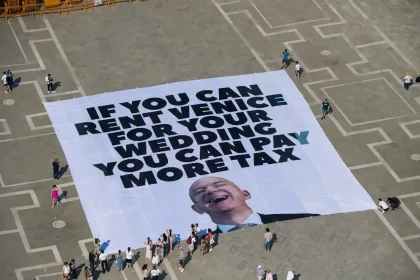 Activists unveil 65-ft banner in Venice urging Jeff Bezos to pay more tax as he hosts lavish wedding - Greenpeace slams billionaire excess amid climate and tax inequality.