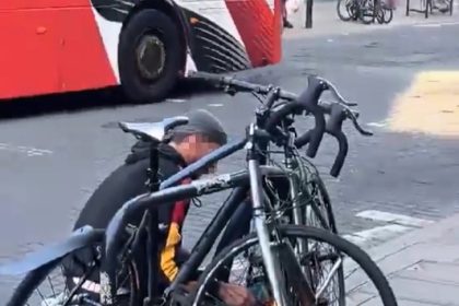 A man was caught on camera using an angle grinder to cut a bike lock outside Marks and Spencer in Dalston, London, sparking outrage and disbelief from shocked onlookers.