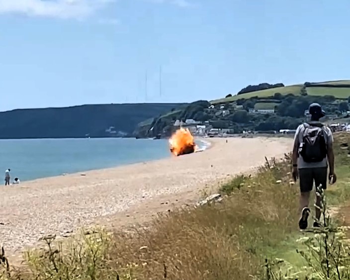 A bomb was safely detonated by the Royal Navy at Slapton Sands, Devon, stunning beachgoers as white smoke and debris filled the air during the dramatic operation.