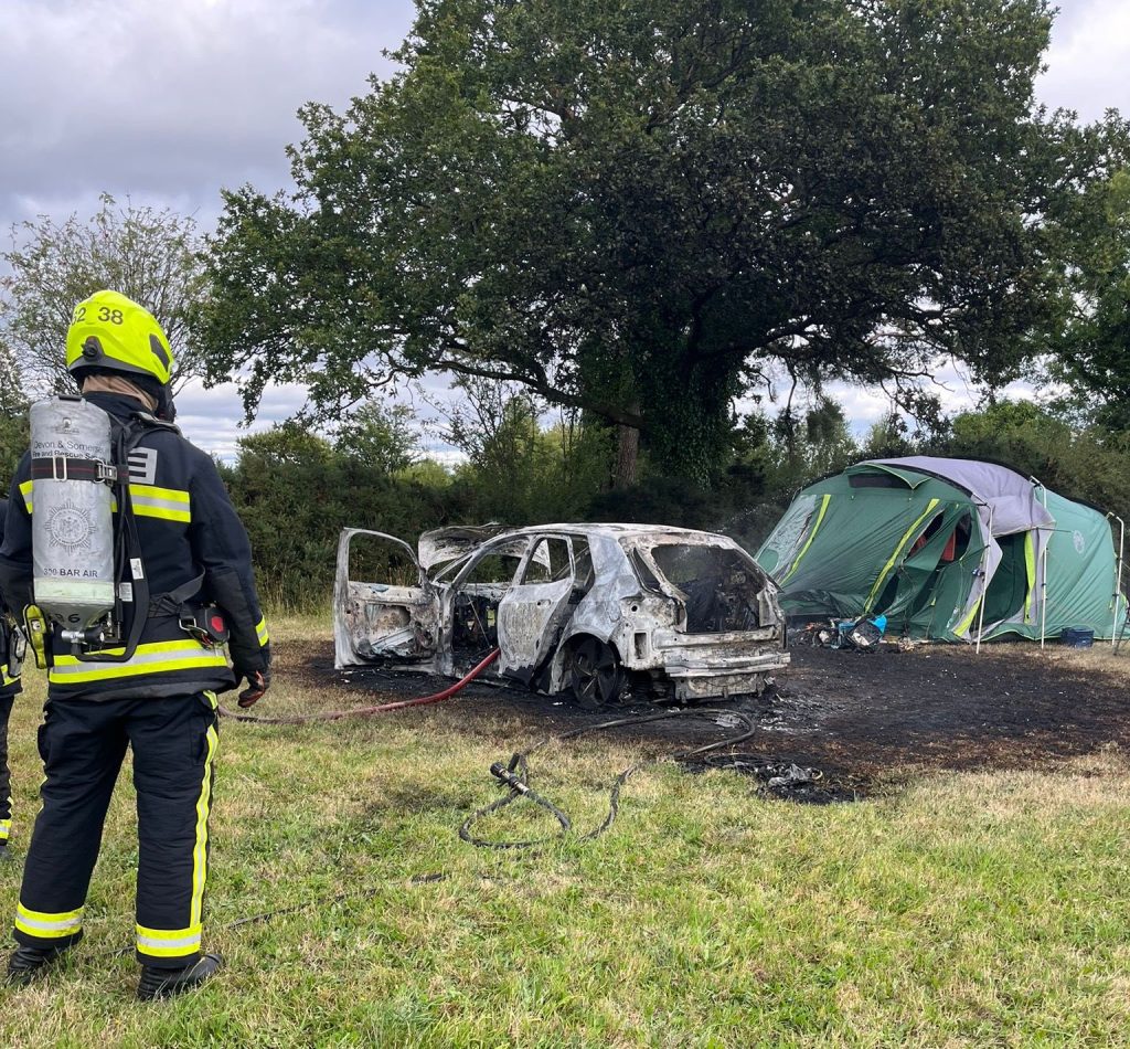 Campers were left stunned after an electric car burst into flames at a Devon campsite, torching a nearby tent. Fire crews contained the blaze, but both were destroyed.