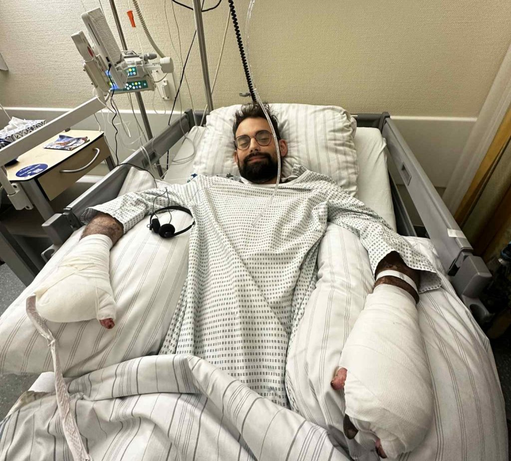 A dad-of-five lost his legs and fingers to a rare infection on holiday. Now, his wife carries him up 5 floors daily while fundraising for an external elevator.