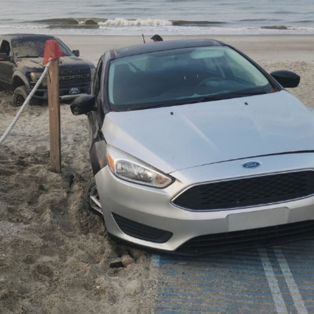 Cars got stuck in sand after driving on Oak Island beach, damaging a vital wheelchair access mat. Officials are assessing costs and drivers face multiple citations.