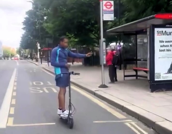 E-scooter rider crashes into lamppost while riding hands-free in Hackney - viral clip sparks mix of laughs and concern as nearby ambulance is spotted.