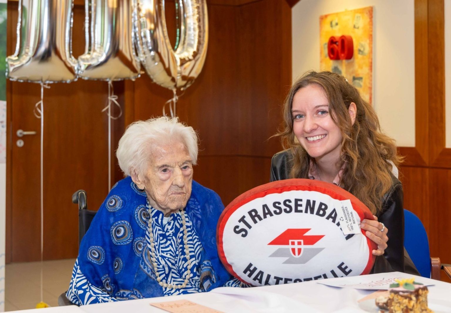 Sweet-toothed Emma Wenda celebrated her 110th birthday with a rum-soaked cake, marking a life spanning two world wars, a helicopter ride at 95 and new teeth at 103.