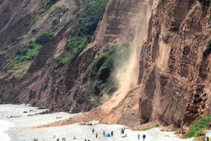 Massive cliff collapse at Budleigh Salterton beach sends red dust skyward and cuts off sunbathers - lifeboat crews rescue stranded people as path is closed.