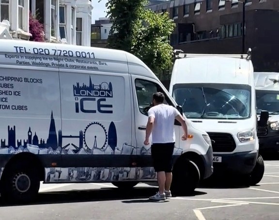 Van driver explodes in road rage during London heatwave, headbutting a window and shouting at an ice van driver who stayed calm as stunned bystanders watched in disbelief.