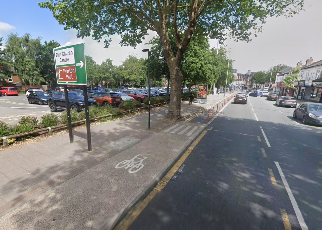 A black Vauxhall Insignia burst into flames in a Birmingham car park, spreading to fencing and nearby vehicles before firefighters quickly extinguished the engine blaze.