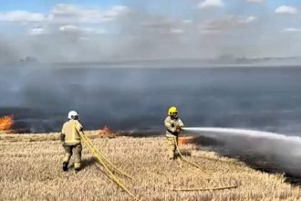 Firefighters tackled a massive crop blaze in Feltwell, Norfolk, as an amber heat alert gripped Britain. The fire destroyed acres of farmland amid one of the hottest, driest years.