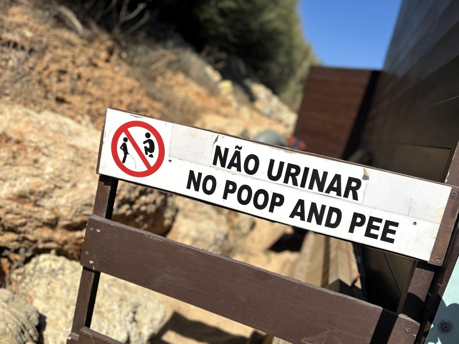 Holidaymakers at Santa Eulália beach in Portugal are warned not to "poop and pee" on the beach with a humorous sign. The notice features images of a man urinating and defecating.
