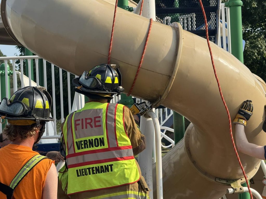 Man trapped in children’s playground slide cut free by firefighters in sweltering heat dome at a Connecticut school - rescue leaves slide destroyed just before term.