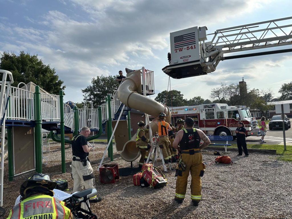 Man trapped in children’s playground slide cut free by firefighters in sweltering heat dome at a Connecticut school - rescue leaves slide destroyed just before term.