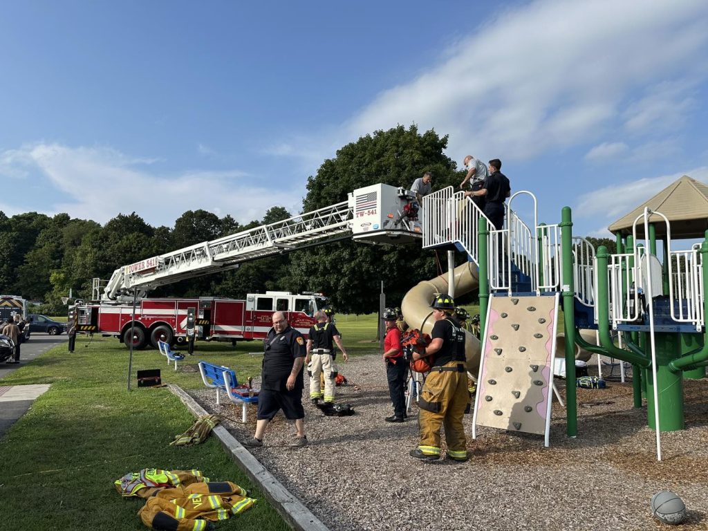 Man trapped in children’s playground slide cut free by firefighters in sweltering heat dome at a Connecticut school - rescue leaves slide destroyed just before term.