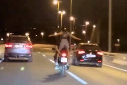 Motorbike passenger caught doing Titanic pose on Spanish motorway goes viral as reckless stunt near Marbella sparks shock and jokes about Jack and Rose moment.