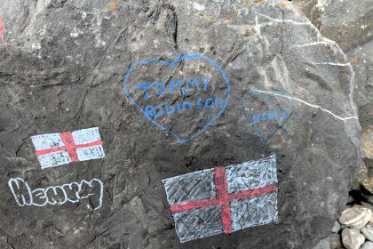 Residents outraged after English flags and political graffiti deface sacred National Trust beauty spot at Stackpole Quay in Pembrokeshire near world famous Barafundle beach.