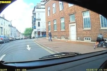 Hero dad Chris Topps jumped from his car to help a lone cop wrestling a suspect outside a police station in Torquay - pinning him down until backup arrived.