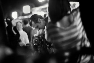 Street photography competition showcases striking moments from around the world including a Times Square kiss, Houhai lake swimmers, urban life scenes and global artistry.