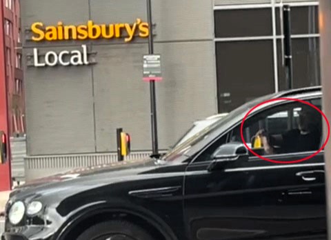 Gary Neville spotted using his phone at the wheel of his £170k Bentley in Salford - shocking fans as footage emerges of the ex-United star risking a driving penalty.