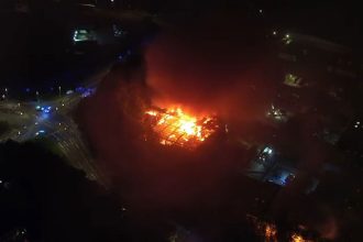 Drone captures huge blaze at Swindon industrial estate after explosion as flames and smoke tower over the area. Residents told to stay indoors while crews battled fire.