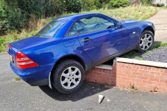 Mercedes left dangling on wall in Myddle dubbed one of Britain’s worst parking fails - police seize untaxed SLK after stunned locals report dangerous sight.