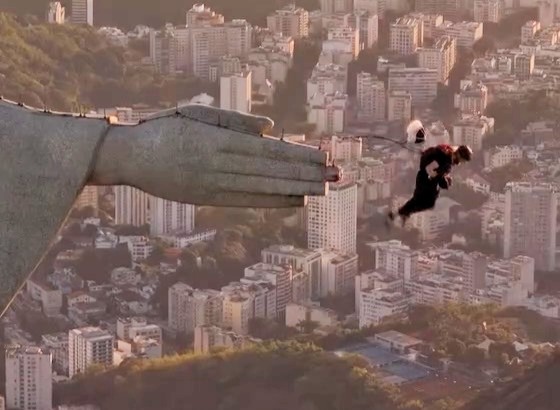 Daredevil under investigation after parachuting from Christ the Redeemer in Rio - shocking drone footage captures illegal stunt as police hunt suspects behind the act.