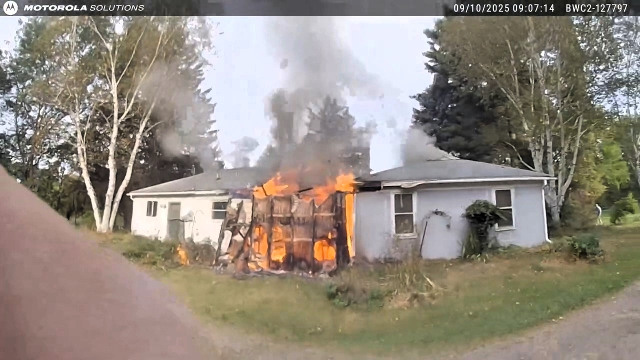 Hero firefighters rescue 76-year-old pensioner from blazing Michigan house fire - dramatic video shows smoke-filled mission as man suffers burns and critical injuries.