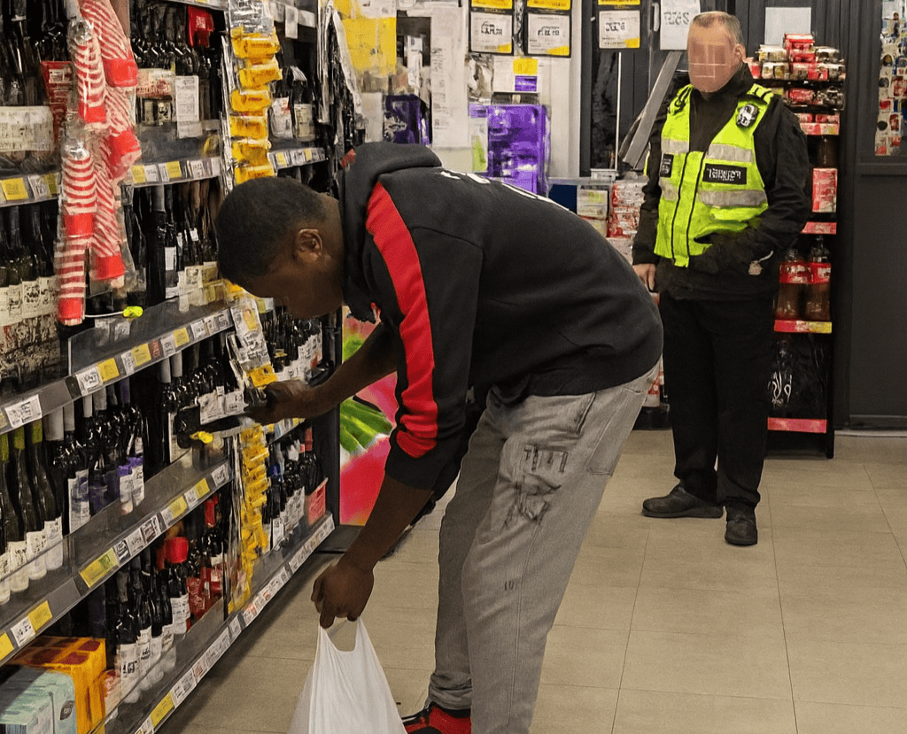 Brazen thief caught on camera stuffing wine into bag before fleeing Tesco with crate of Stella Artois in south London - shocked shopper pleads with him to stop.
