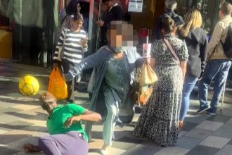 Woman slammed for rude stunt after knocking football off street performer’s head in Ilford. While he laughed it off, viewers branded her childish and disrespectful.