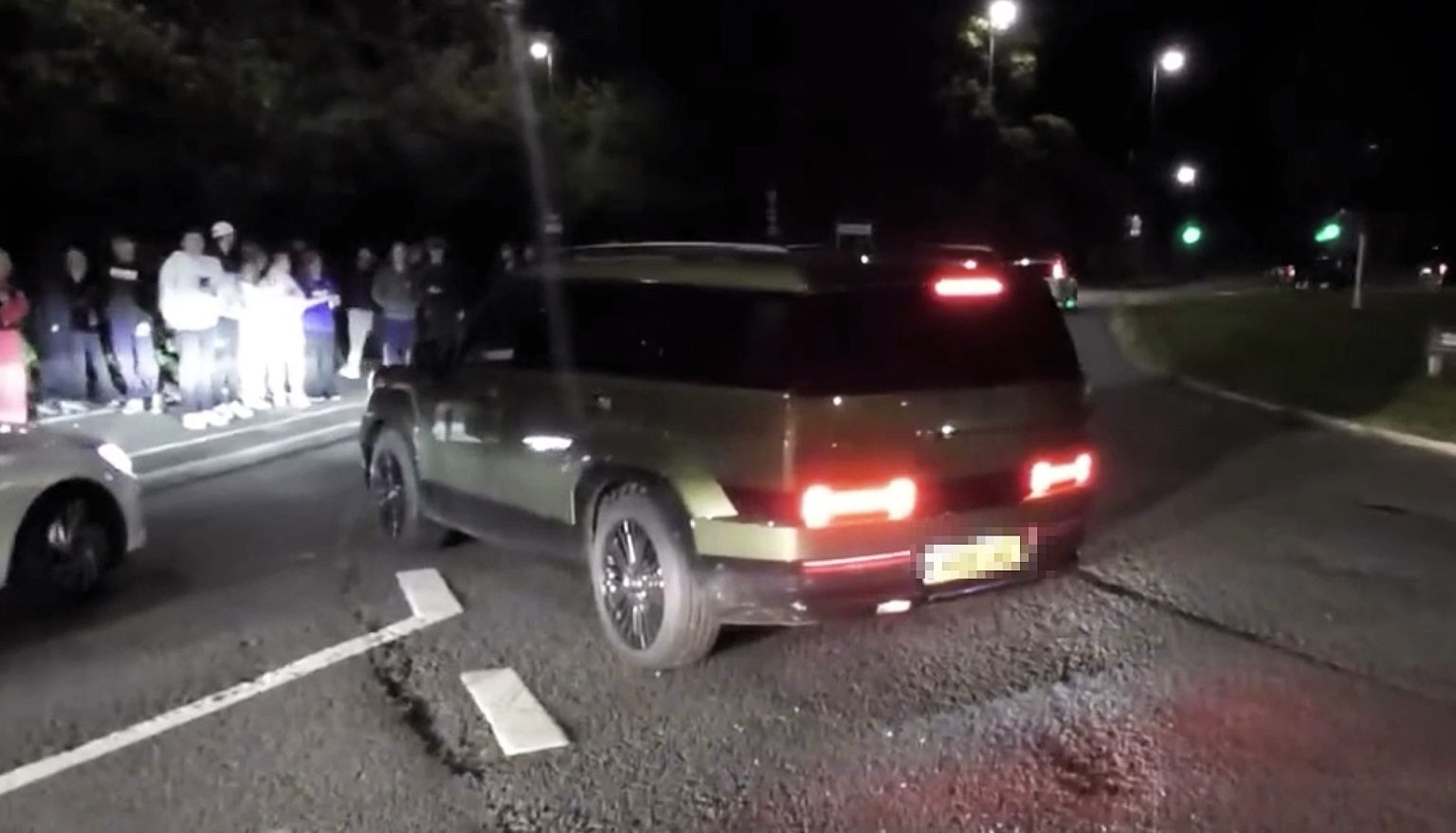 An angry driver blocked a road to stop a noisy car meet on the A34 near Alderley Edge - chaos erupted as boy racers clashed and police were called to disperse the crowd.