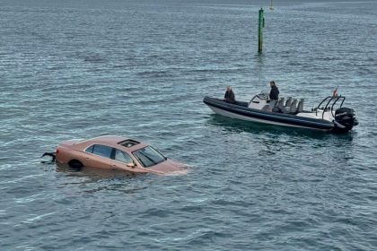 A Bentley plunged into the sea at Sandbanks after falling from a car park, with quick-thinking passers-by pulling the driver through the sunroof before the car sank.