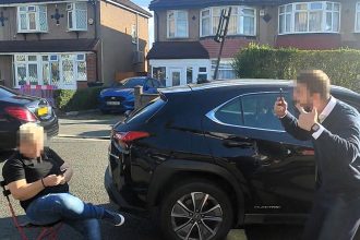 A woman caused chaos in west London by sitting on a chair to reserve a parking space for a friend sparking a heated road rage row with a furious driver and bystanders.