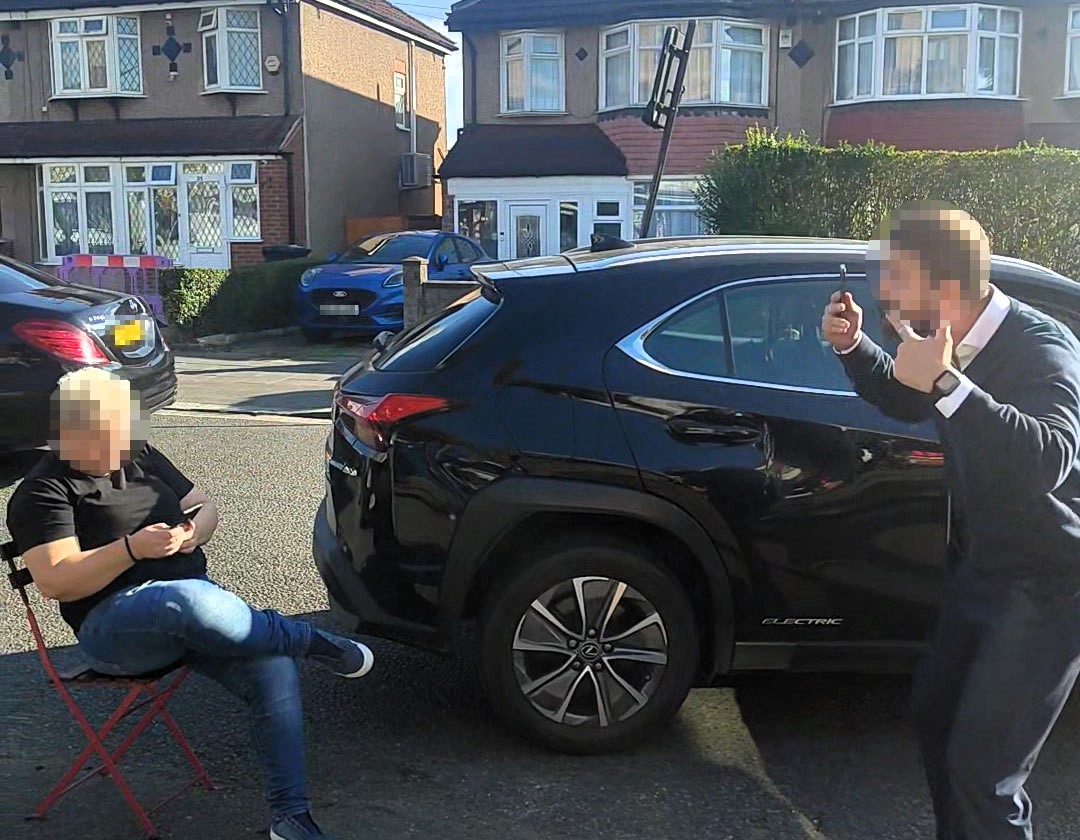 A woman caused chaos in west London by sitting on a chair to reserve a parking space for a friend sparking a heated road rage row with a furious driver and bystanders.